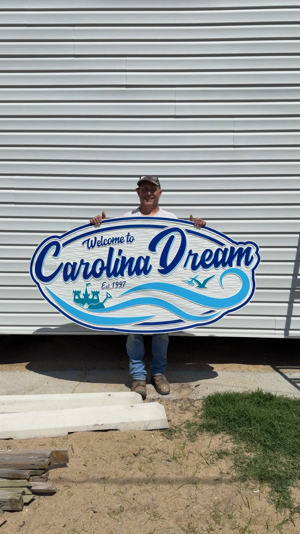 Customer holding the completed blue and white Carolina Dream sign